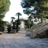 Siamo in un cortile con numerose panchine e dinanzi a noi si aprono due scalinate monumentali